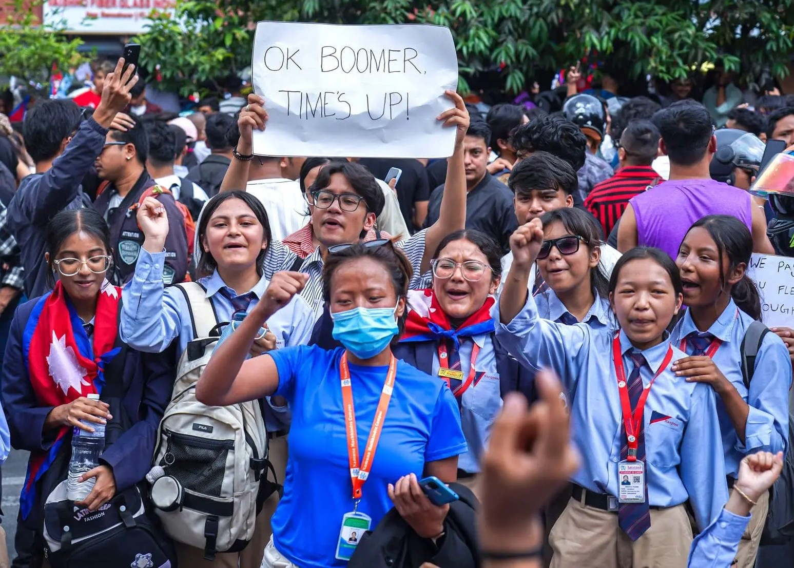 Gen Z protesters marching with signs and raised fists on September 9, 2025.