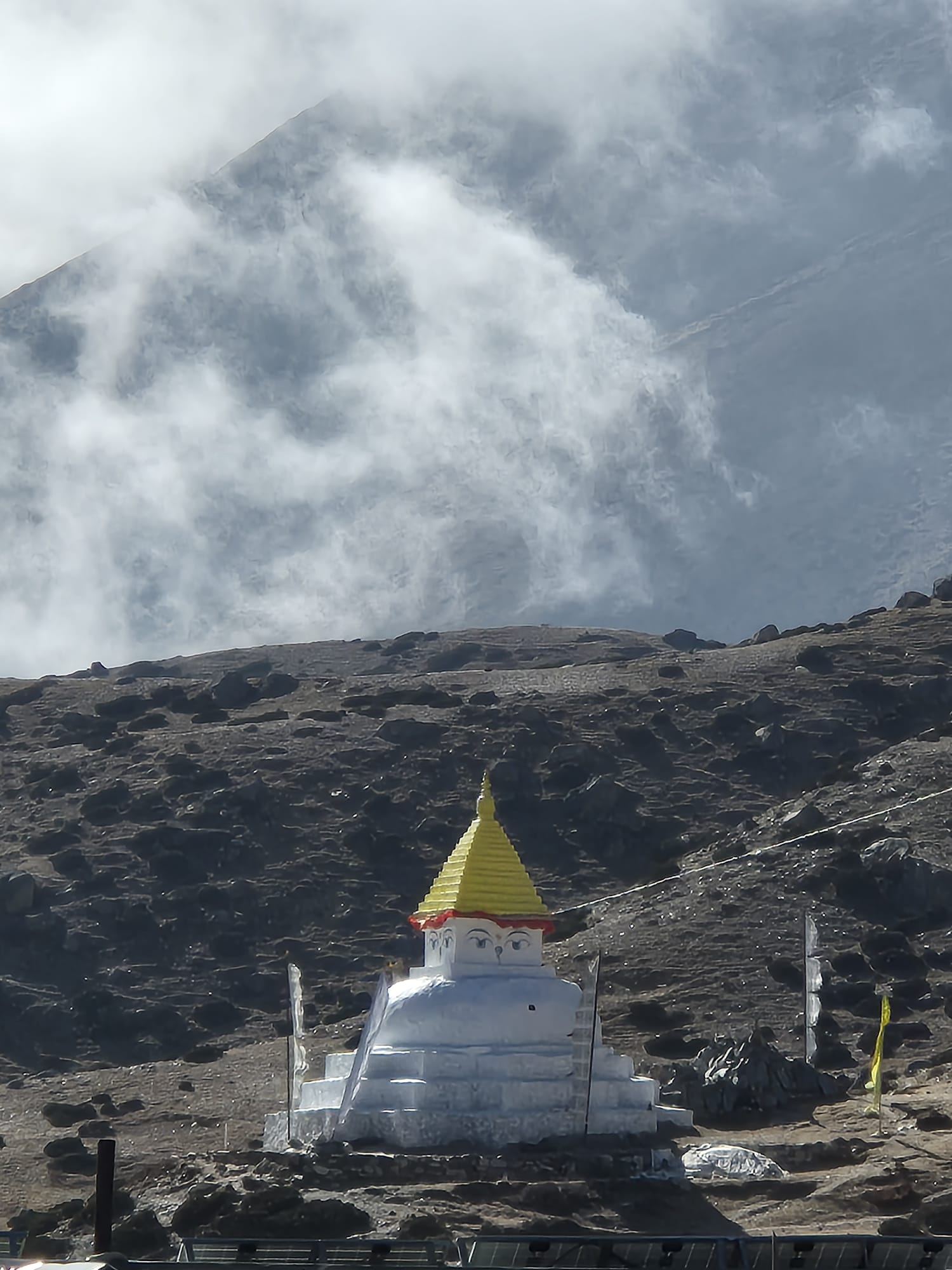 Beautiful white chorten set against the majestic Everest landscape, with snow-capped peaks towering in the background.