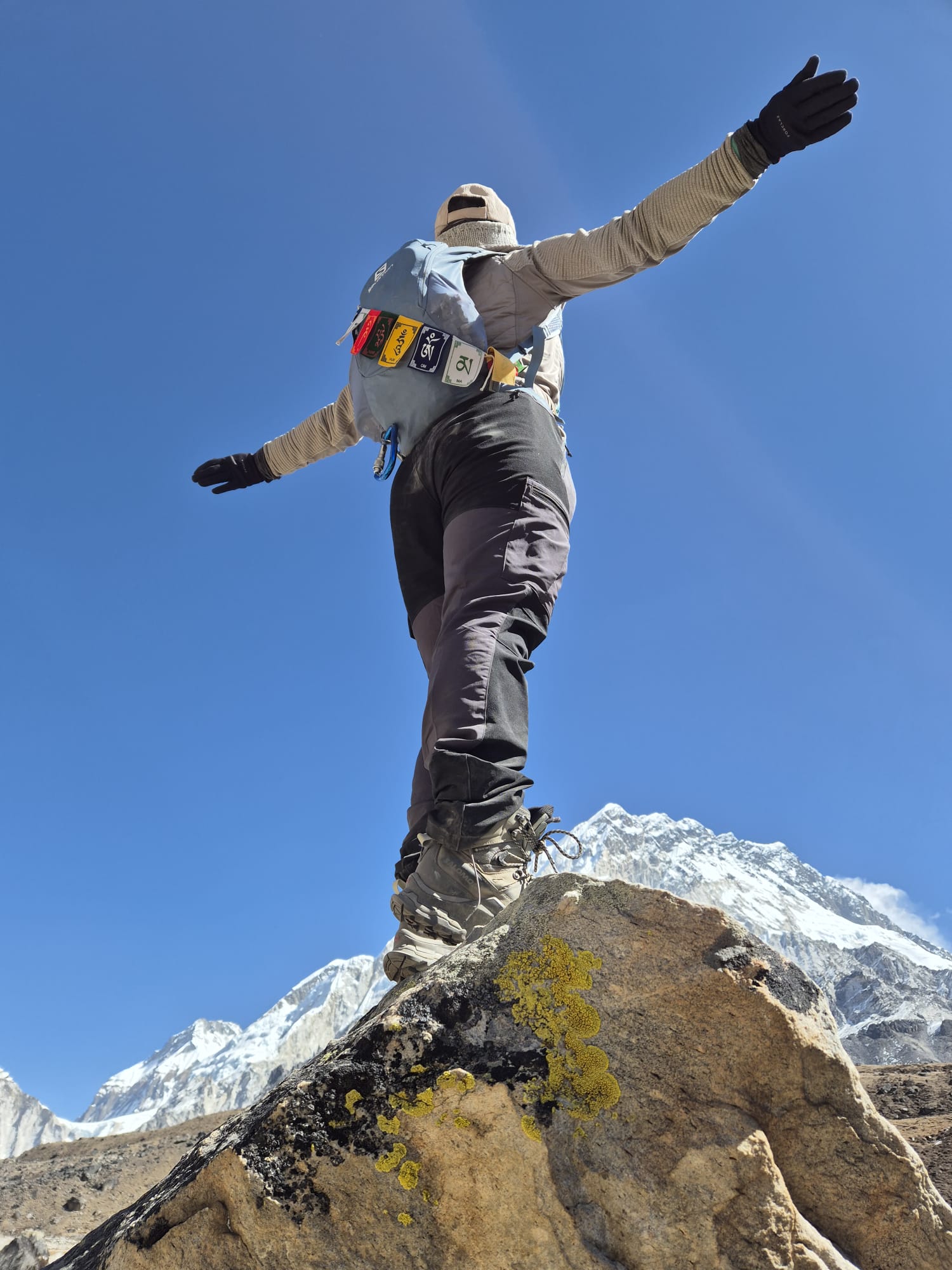 Guest happily posing for pictures with majestic Himalayan mountains in the background.