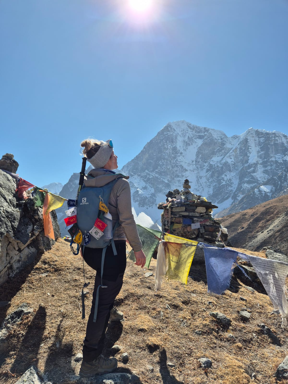 Guest smiling and posing for pictures outdoors with scenic mountains in the background.