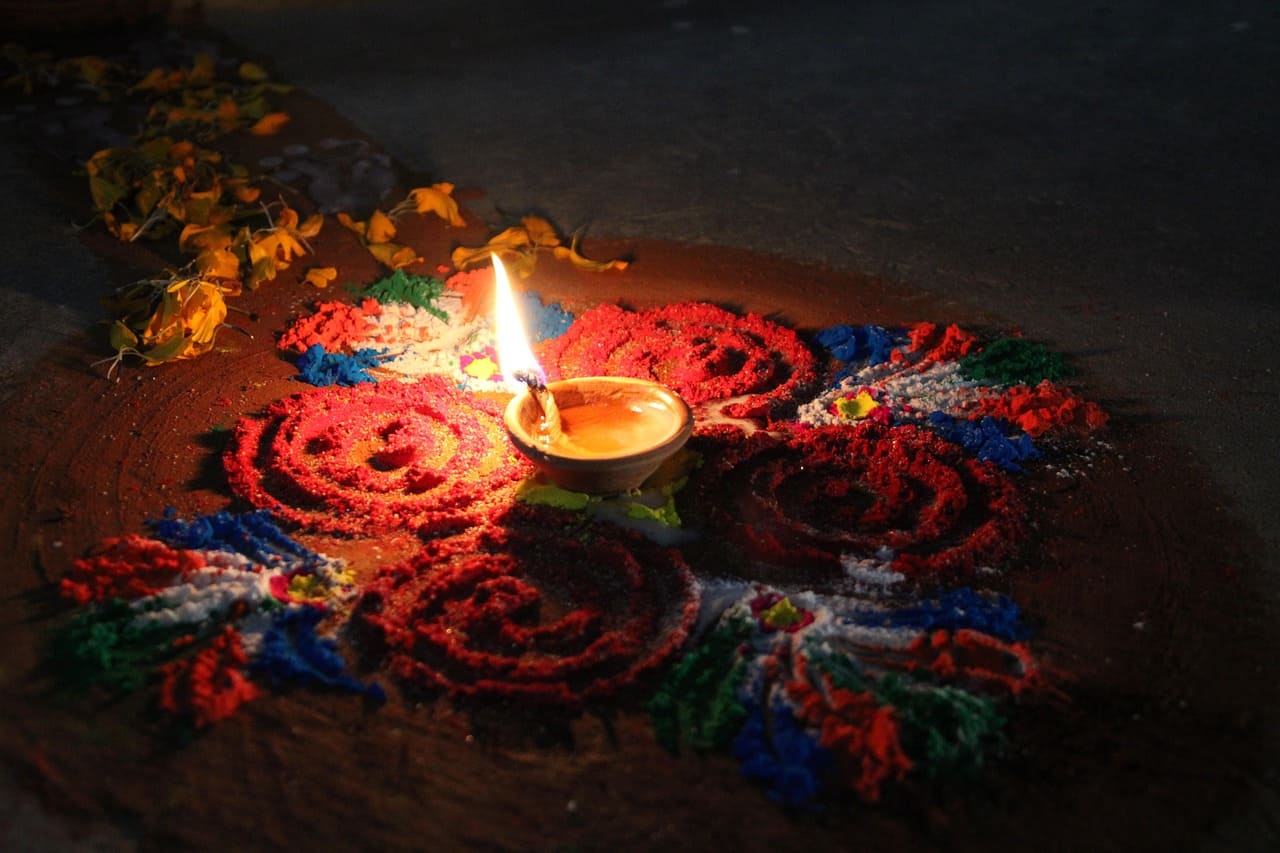 Celebration of Tihar Festival in Nepal with vibrant lights, decorated homes, and people honoring traditions with candles and flowers